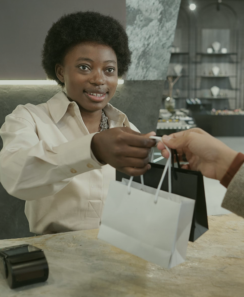 Store employee helping customer